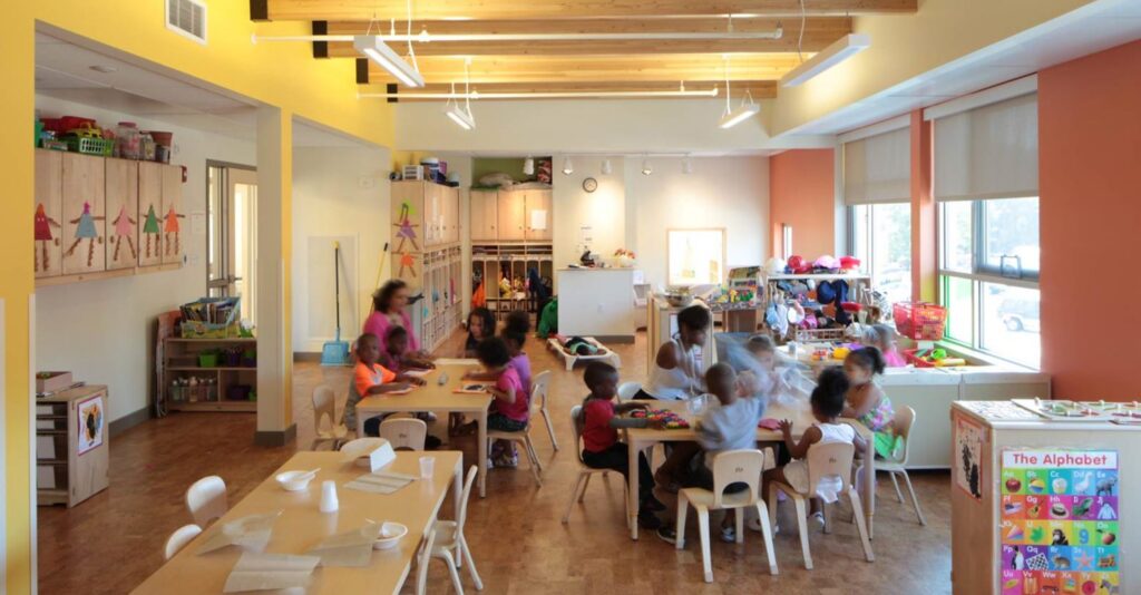 Active scene of children learning in a big, bright, and clean classroom